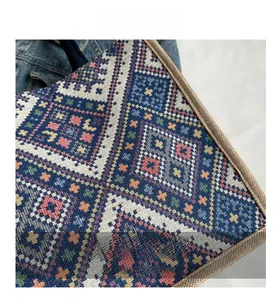 Close-up of ethnic style woven tote bag with colorful geometric patterns and canvas edges