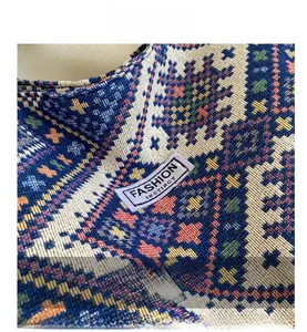 Close-up of geometric woven tote bag featuring colorful patterns and white fashion label