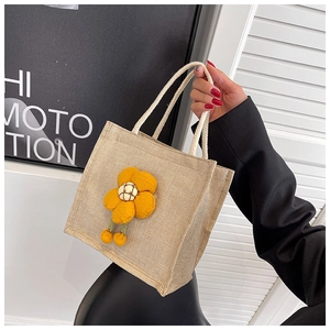 Detailed view of linen lunch bag with large 3D yellow flower and cotton rope handle