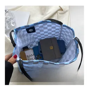 Top view of blue checkered quilted tote bag showing spacious interior and magnetic clasp