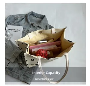 Detailed interior of canvas tote bag showing large capacity and internal zipper pocket
