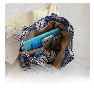 Top view of a large capacity ethnic tote bag showing organized storage of various daily items