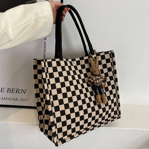 Large checkerboard canvas tote bag with woven handles and a cute bunny plush charm
