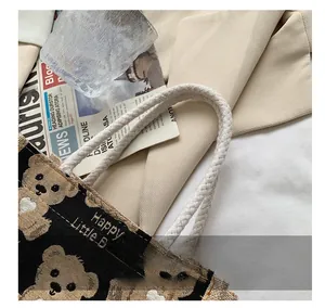 Dettaglio del manico in corda di cotone bianco sulla borsa tote con stampa di orsi