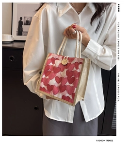 Detail of canvas bento bag with pink heart prints and wooden button closure