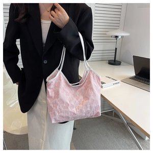 Detail of pink floral jacquard tote bag showing soft 3D flower texture and white strap