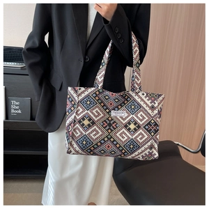 Close-up of ethnic geometric pattern tote bag with Fashion Instinct label on model