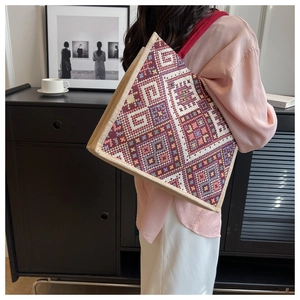 Detailed shot of ethnic geometric pattern on large capacity woven shoulder tote bag