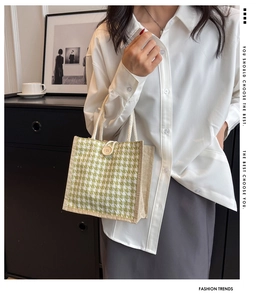 Dettaglio borsa in lino pied-de-poule verde con manico in corda e bottone decorativo in legno