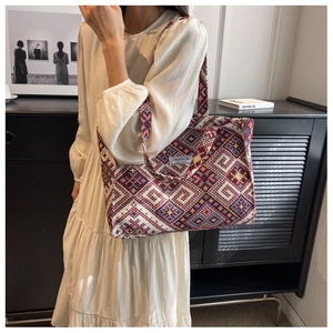 Close-up of ethnic tote bag with woven geometric patterns and a minimal brand label