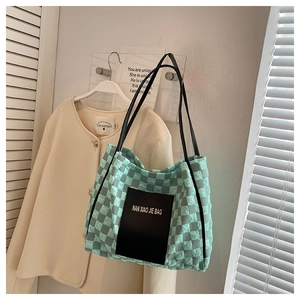 Quilted checkerboard tote bag detail featuring mint green and grey nylon with leather patch