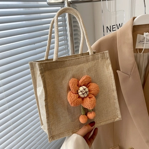 Linen bento bag with large yellow fabric flower and woven cotton rope handles