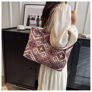 Detail of vintage geometric jacquard tote bag with a white fashion label on the side
