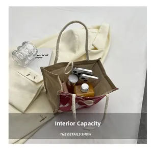 Linen tote bag with red heart patterns showing interior storage capacity and a wooden button