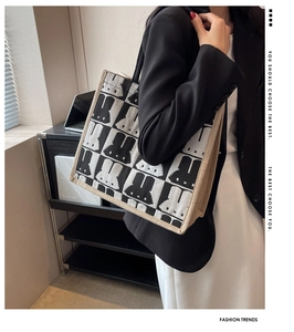 Detail of canvas tote bag with checkerboard pattern and rabbit print on a model