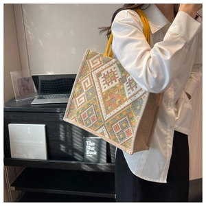 Detailed embroidery with colorful geometric patterns on a large ethnic tote bag