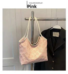 Detailed close-up of light pink tote bag featuring embossed 3D floral textures