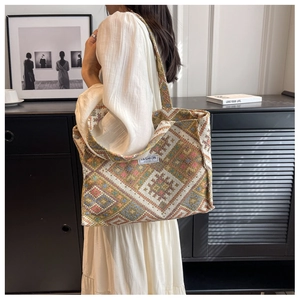 Detail of ethnic geometric woven pattern tote bag with white fashion label