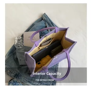 Detail view of purple canvas tote bag interior with large capacity and zipper pockets