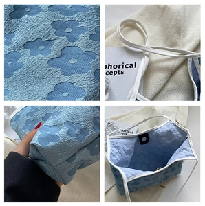 Detail view of blue floral jacquard fabric and magnetic closure on the large tote bag