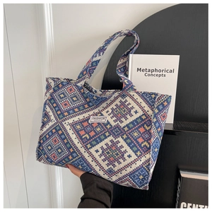 Close-up of geometric jacquard tote bag with ethnic blue weave and Fashion Instinct label