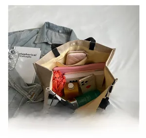 Top view of spacious tote bag interior showing gadgets, umbrella and cosmetic storage