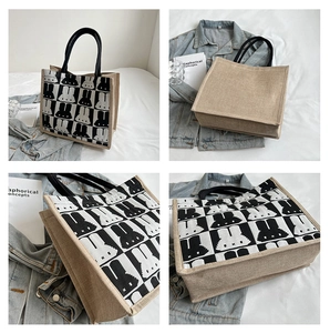 Close-up of canvas and jute tote bag with checkerboard rabbit pattern and woven handles