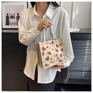 Close-up of heart print canvas bag with burlap sides and woven rope handles