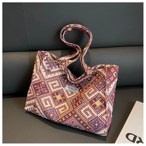 Detailed view of large ethnic woven tote bag with colorful geometric patterns and handles