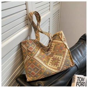 Detail of colorful geometric woven jacquard tote bag with textured ethnic diamond patterns