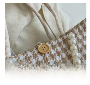 Close-up of retro woven tote bag with wooden button closure and pearl handle details
