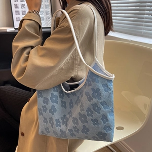 Minimalist light blue floral canvas tote bag shown on model for daily casual wear