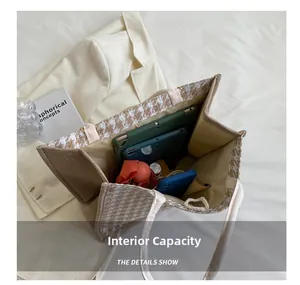 Spacious interior of canvas tote bag showing storage for tablet, phone and umbrella
