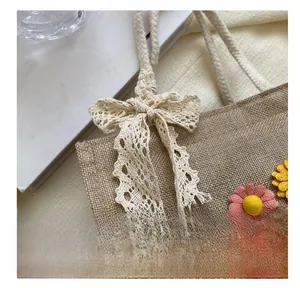 Close-up of linen handbag with beige lace bow and 3D floral sunflower decorations