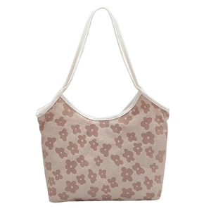 Minimalist canvas tote bag with pink floral pattern and white trim on white background