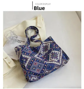 Close-up of blue geometric ethnic knit tote bag with a white Fashion woven label