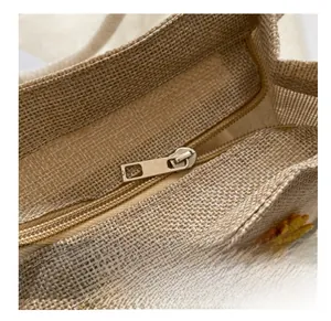 Macro view of smooth metal zipper and floral texture on woven linen handbag