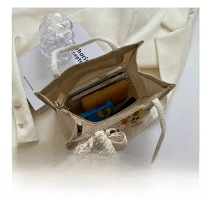 Linen tote bag storage detail showing capacity for phone, wallet and cosmetics items