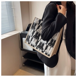 Detail view of large canvas tote bag featuring black and white checkered rabbit pattern