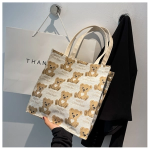 Detail of canvas tote bag with cute brown bears and Happy Little Bear print