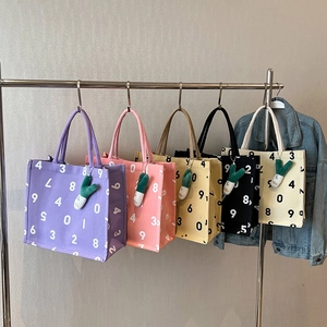 Large canvas tote bag with numeric print and plush leaf charm in five assorted colors