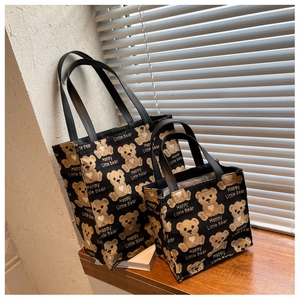 Detailed set of large and small black bear pattern canvas tote bags on a windowsill