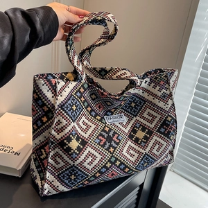 Ethnic style woven tote bag with colorful geometric patterns and fashion instinct label