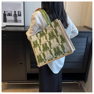Detail view of pixelated green rabbit pattern on a large canvas tote bag for daily use