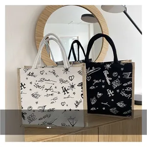 Close-up of linen tote bags with LA graffiti print on a wooden counter display