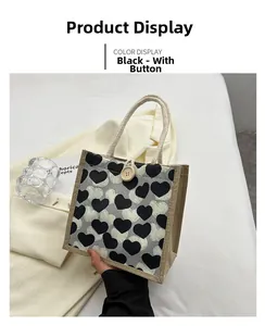 Detail of heart print linen lunch tote bag featuring a round wooden button closure