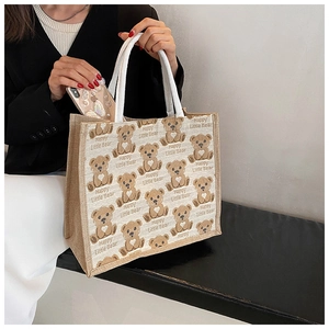 Detail showing high-capacity linen tote with printed cartoon bears and inner pocket