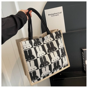 Close-up of checkered rabbit pattern tote bag with durable metal magnetic closure
