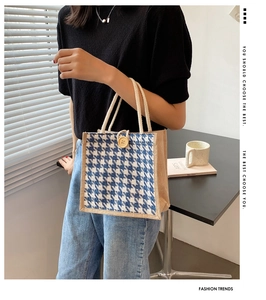 Detailed close-up of a linen tote bag with blue houndstooth pattern and wooden button