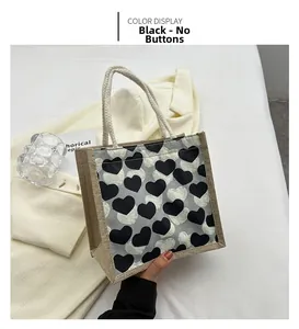 Linen bento tote bag with heart patterns and woven handles shown in a lifestyle setting